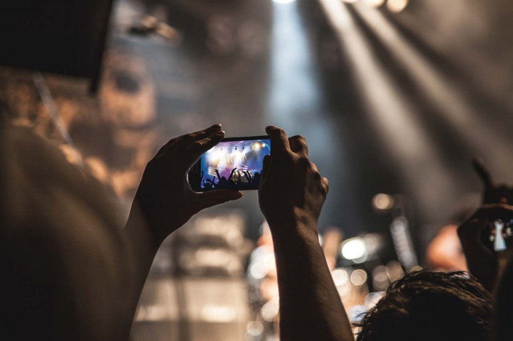 hands-smartphone-taking-photo-festival