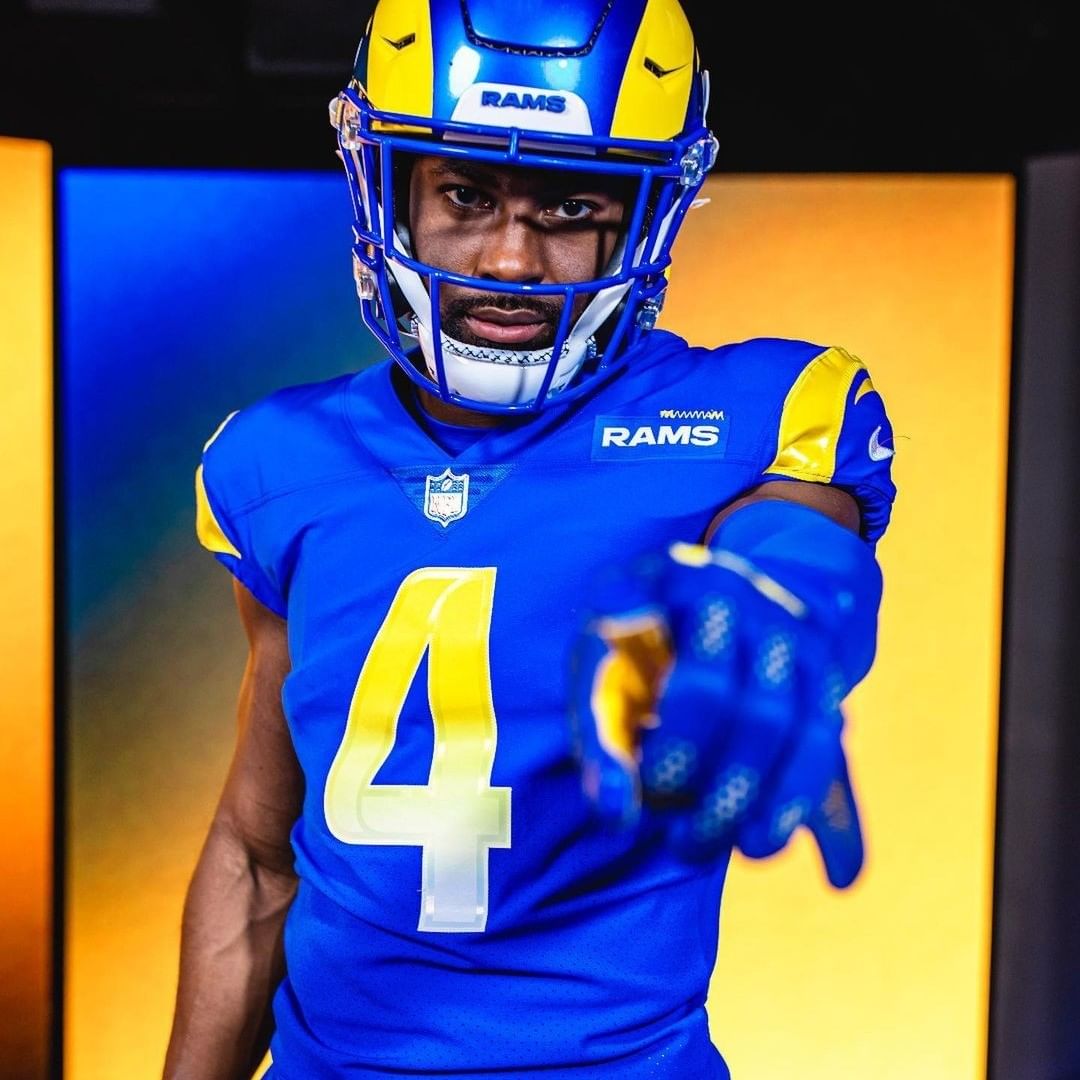 Image of Chargers football teammates in front of LED Display