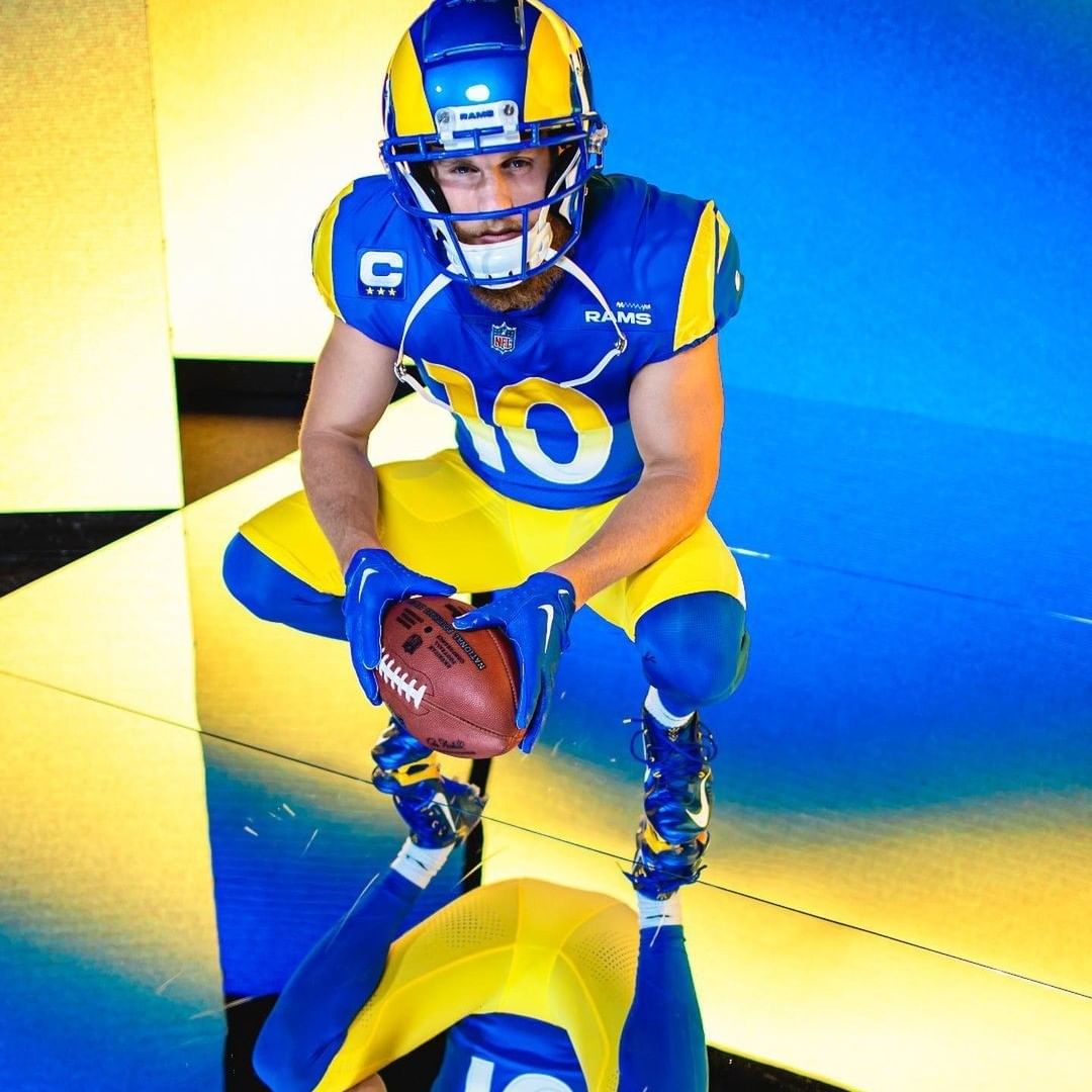 Image of Chargers football teammates in front of LED Display