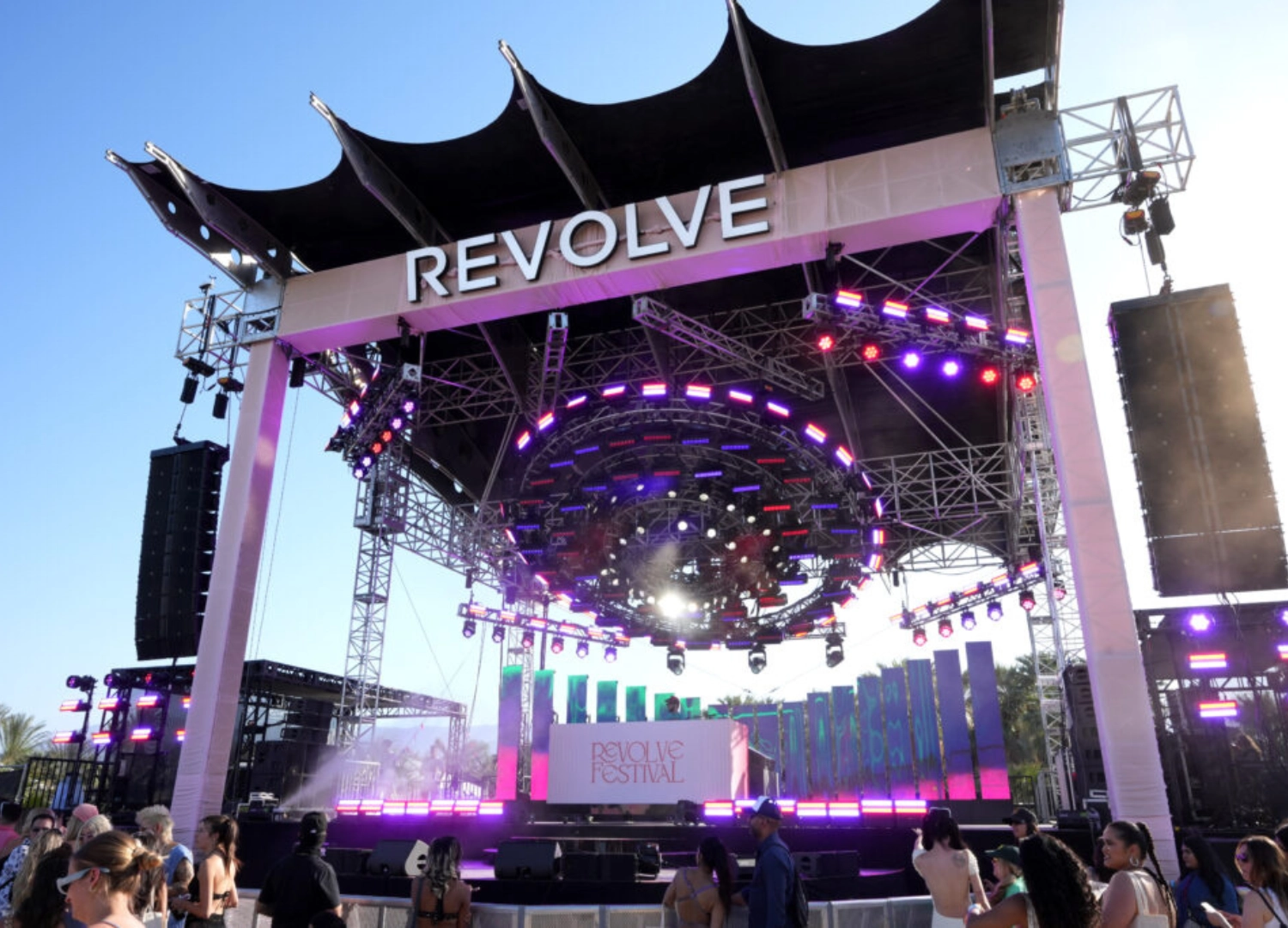 Image of stage with vibrant LED display and performer