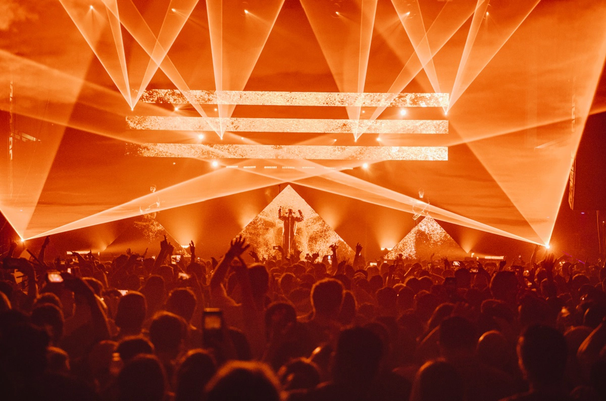 Image of DJ Zhu performing on stage in front of LED panels