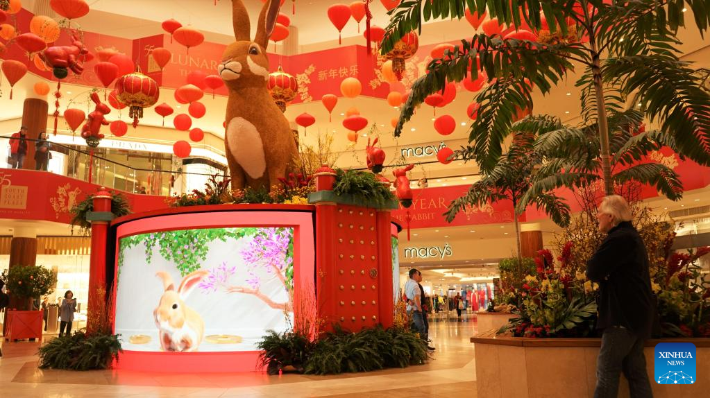 Image of Lunar New Year display of rabbit sitting atop a LED Screen